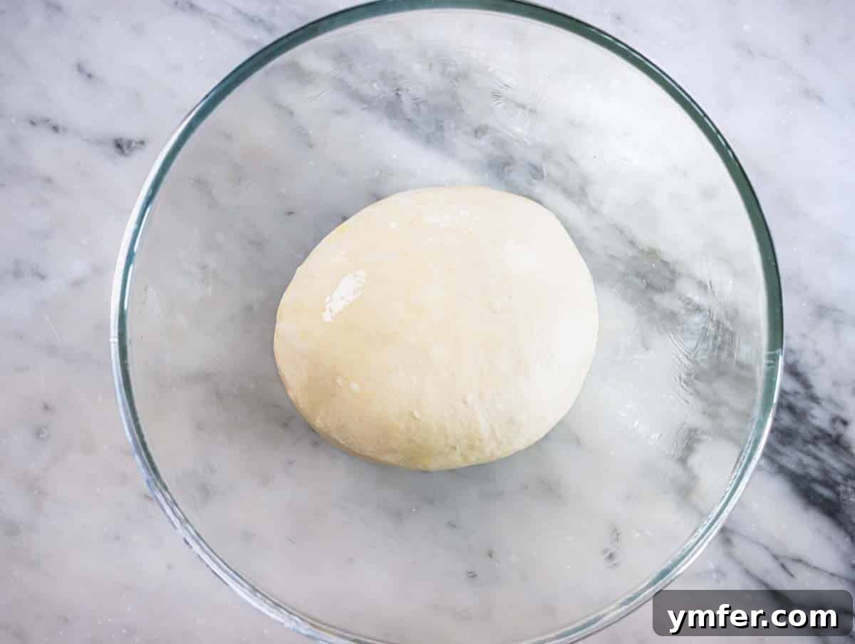 Perfect Ooni Pizza Dough Formula 17 Pizza dough in a glass bowl before the second proofing
