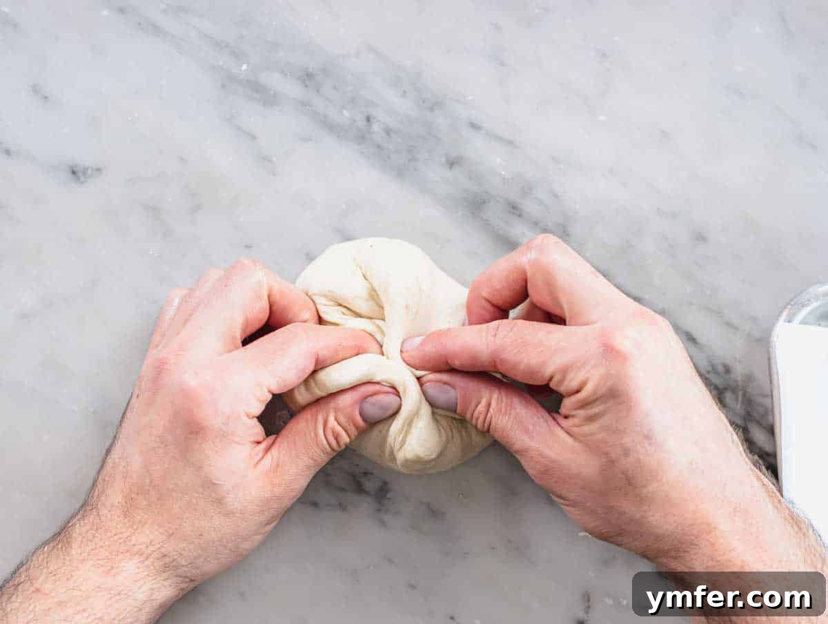Perfect Ooni Pizza Dough Formula 23 pinching the dough ball
