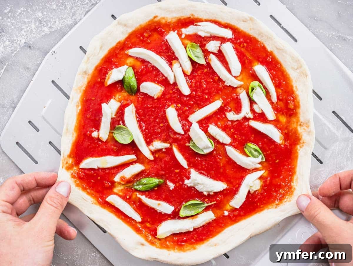 Perfect Ooni Pizza Dough Formula 32 stretching the ooni pizza before baking it