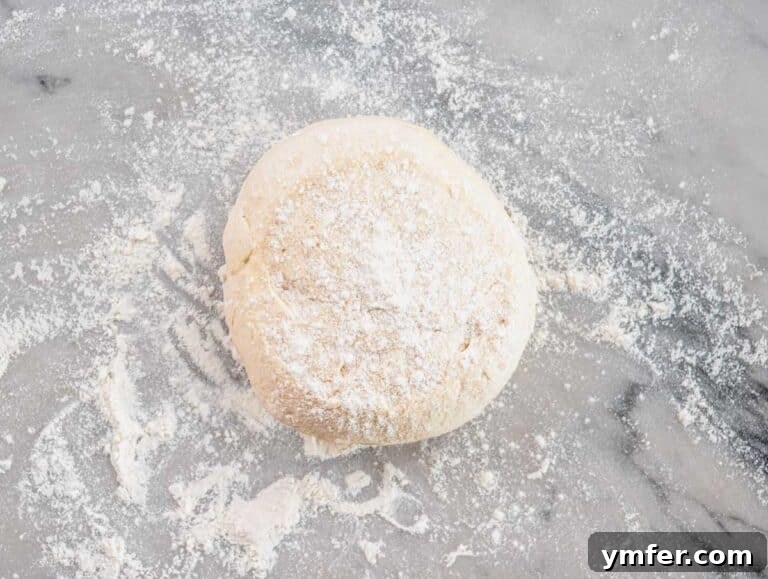 Perfect Ooni Pizza Dough Formula 51 pizza dough on a worktop with flour