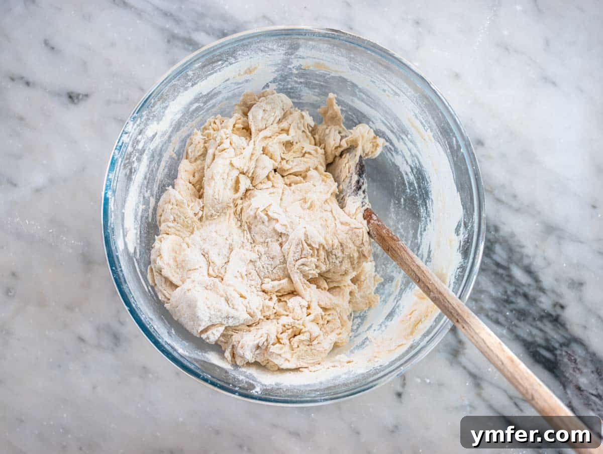 Perfect Ooni Pizza Dough Formula 10 flour and water mixed together in a glass bowl