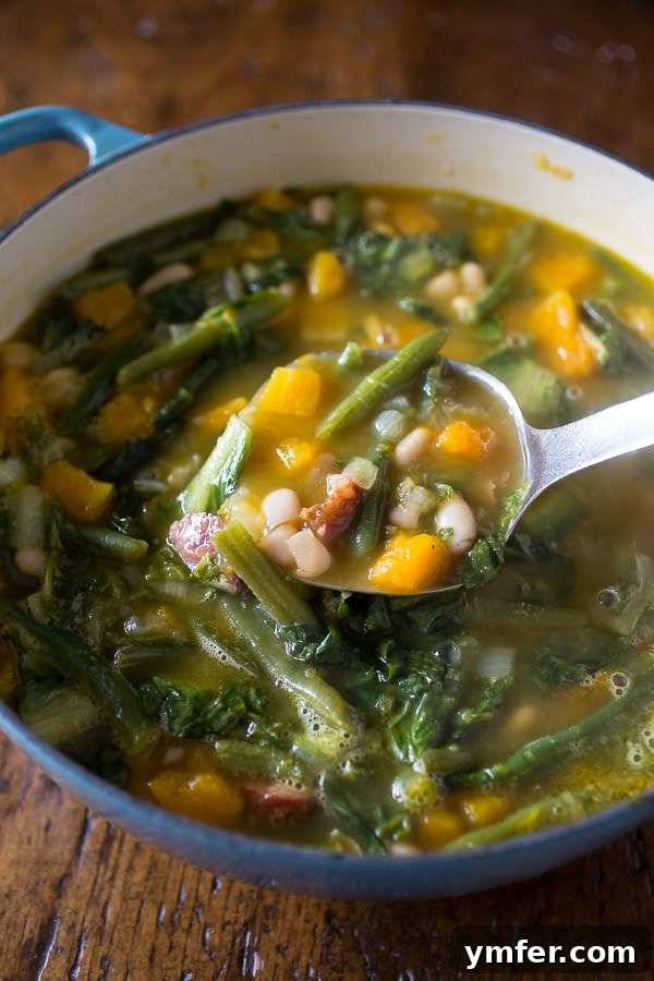 Easy Butternut Squash Minestrone: Adaptable and Delicious Butternut squash minestrone soup served in a bowl with pesto, ready in just over an hour.