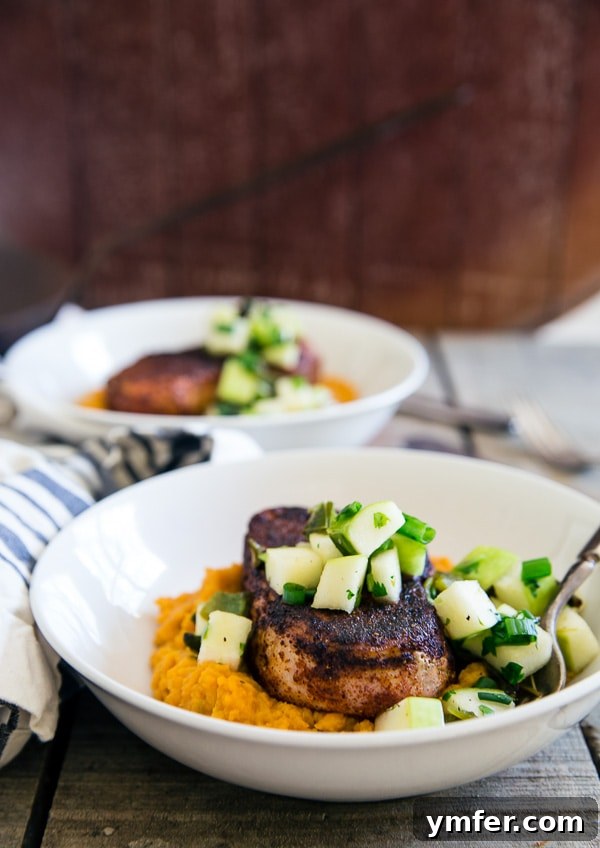 Flavorful spiced pork chops served on creamy mashed sweet potatoes with vibrant charred poblano apple salsa, a quick and comforting winter dinner.