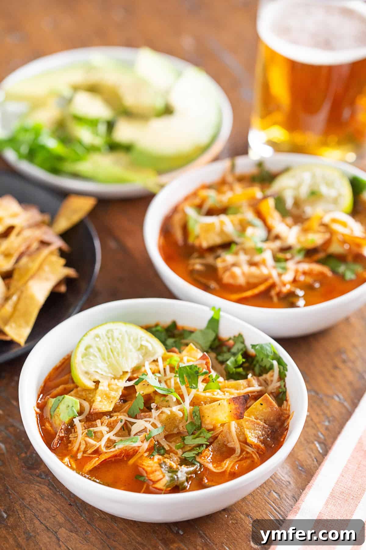 chicken and chard tortilla soup topped with tortilla strips and served with a beer