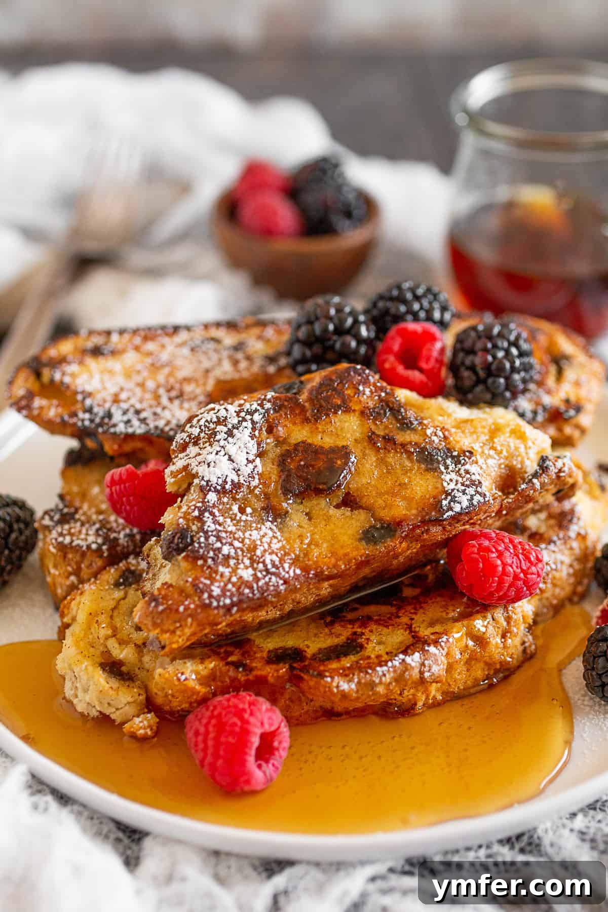 Emerald Isle French Toast 4 A single slice of Irish Soda Bread French Toast on a pristine white plate, garnished with berries.