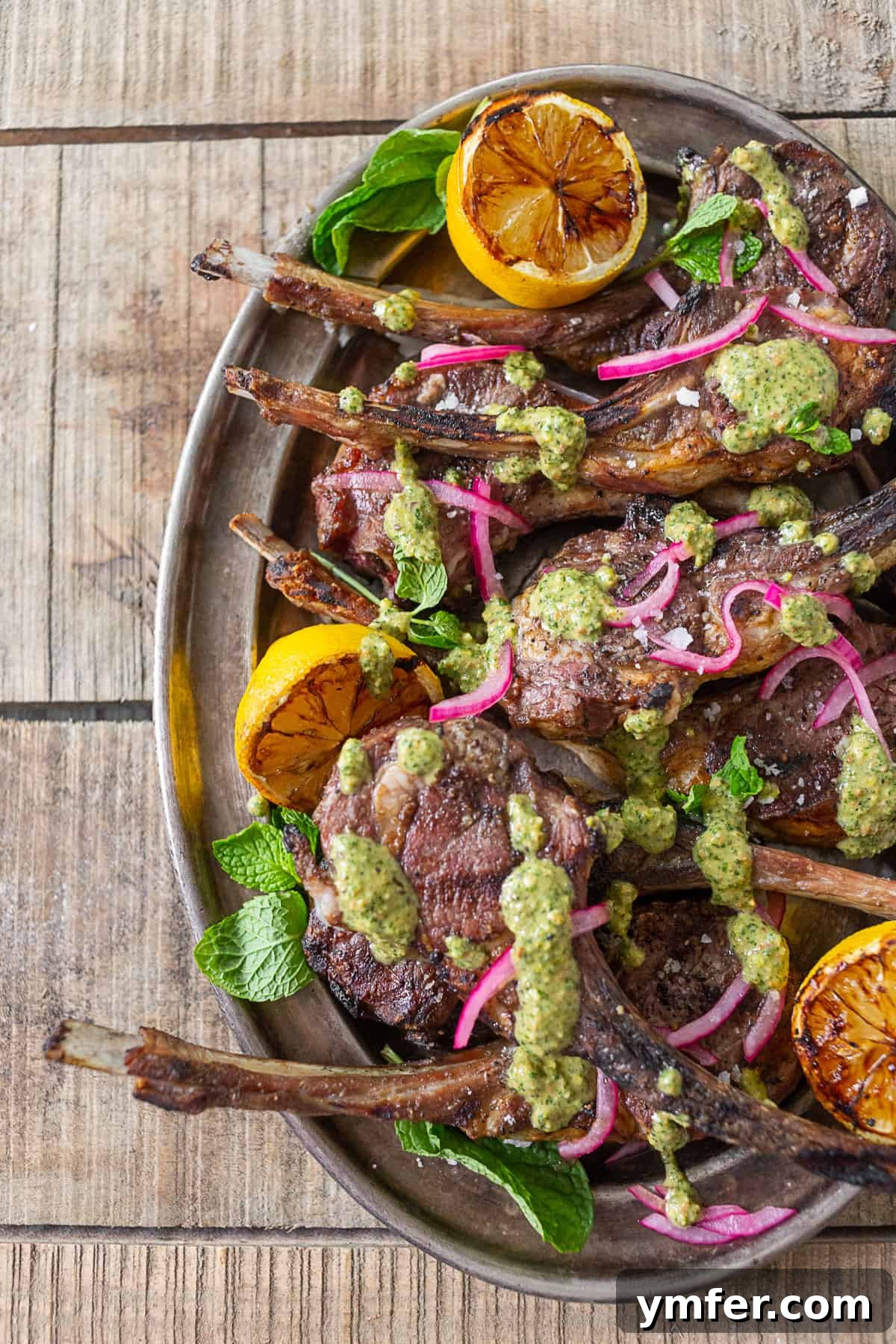Grilled Lamb Chops with Emerald Pistachio Mint Pesto 2 Grilled Lamb Chops with Pistachio Mint Pesto on a serving platter.