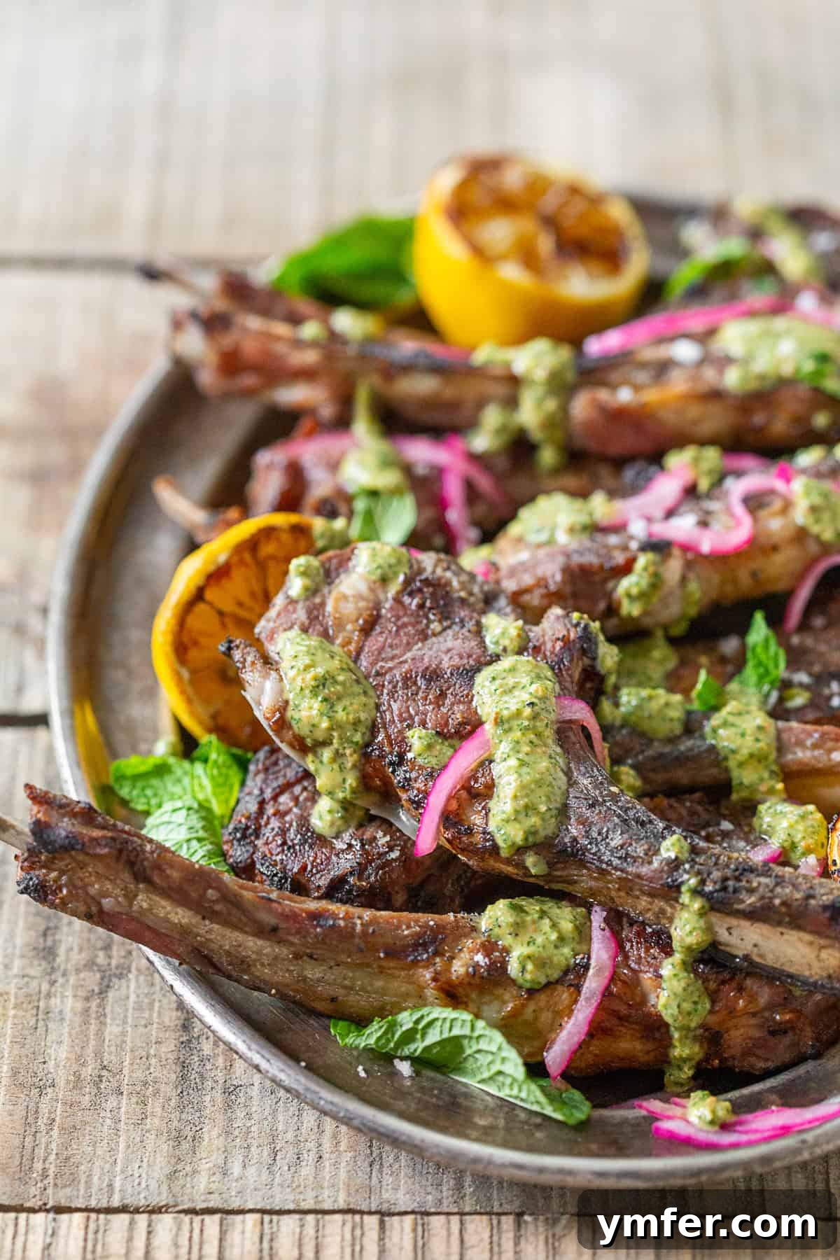 Grilled Lamb Chops with Emerald Pistachio Mint Pesto 4 Grilled Lamb Chops with Pistachio Mint Pesto on a platter.