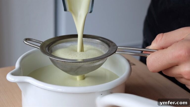 Velvet Pistachio Crème 9 Pistachio custard step 3: Whisking cornstarch into blended pistachio milk in a pot.