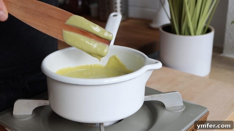 Velvet Pistachio Crème 11 Pistachio custard step 5: Performing the spatula test to check for doneness.