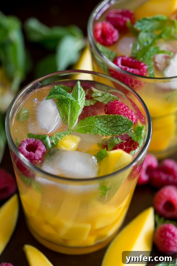 Tropical Raspberry Mango Sangria 2 raspberry mango sangria in a glass