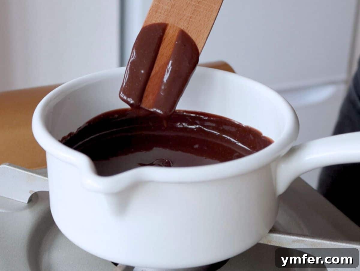 Decadent Chocolate Custard 8 A spatula being used to test the creaminess and readiness of chocolate custard in a pot.