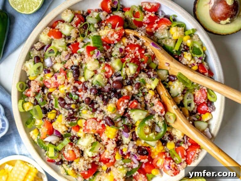 Vibrant Quinoa Bowl 12 Fully mixed quinoa salad in a white bowl with corn and black beans visible.