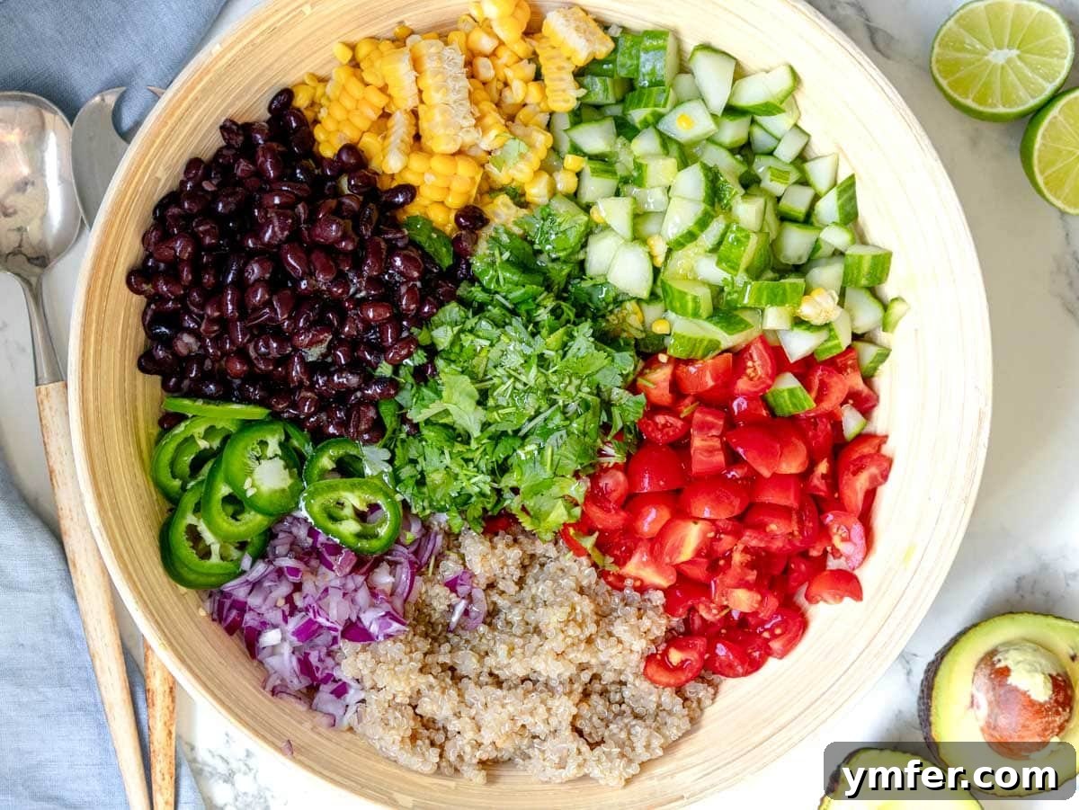 Vibrant Quinoa Bowl 7 Chopped vegetables and black beans in a large mixing bowl, ready for quinoa and dressing.