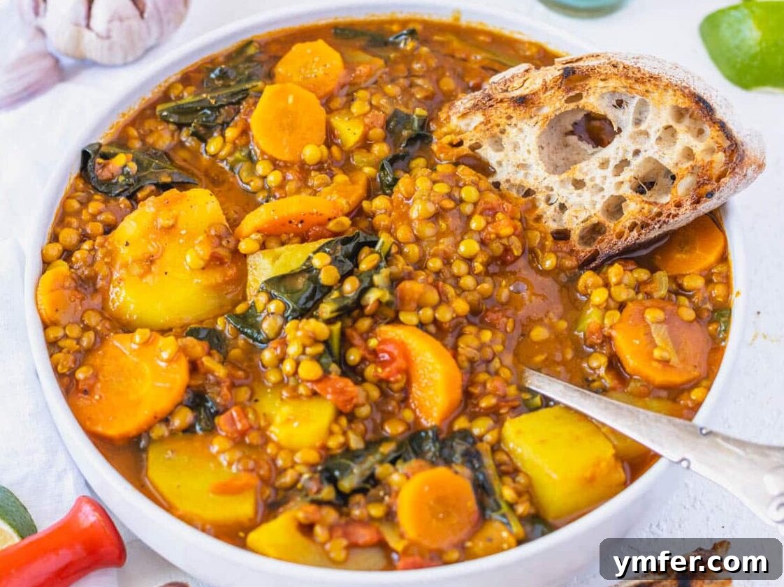 30 Dutch Oven Feasts 19 curry lentil soup with sourdough bread and a spoon
