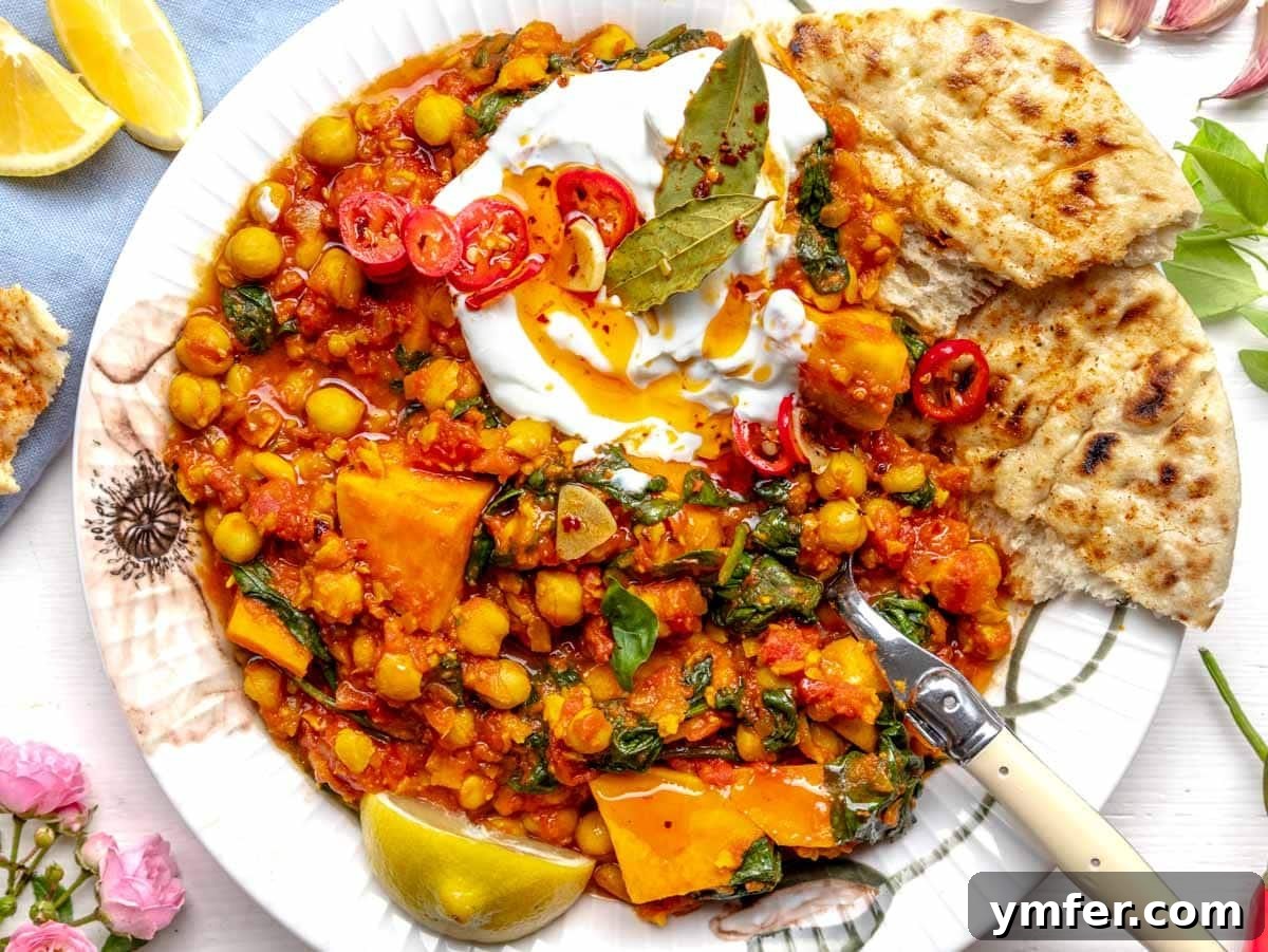 30 Dutch Oven Feasts 9 Chickpea stew with yogurt and chili oil on a plate with flowers
