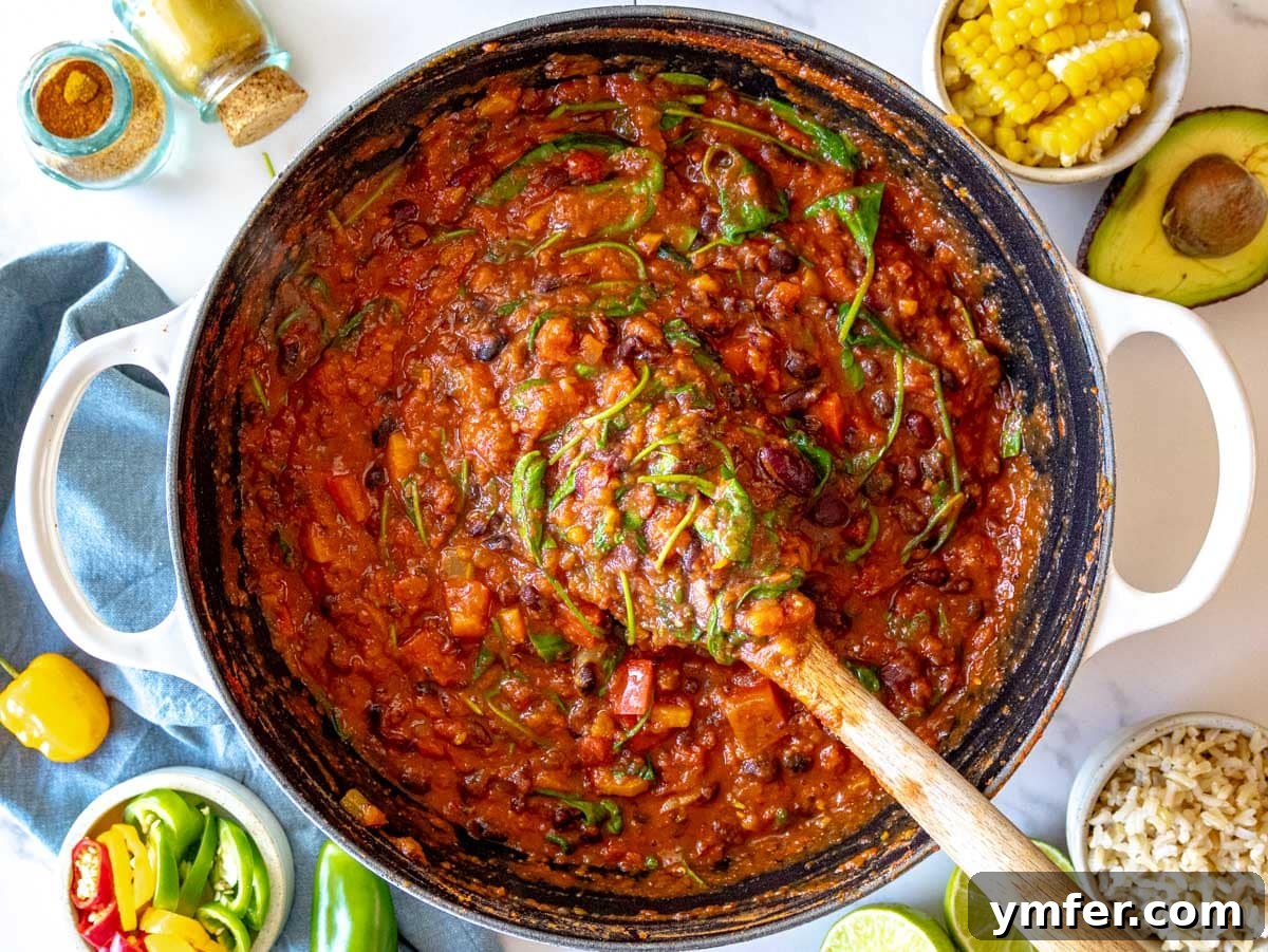 Hearty Veggie Chili 7 creamy vegetarian chili with spinach cooked in a large pot