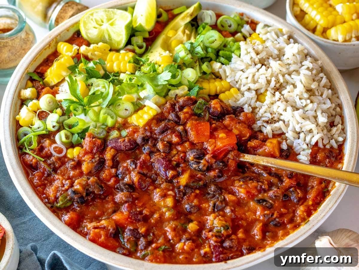 Hearty Veggie Chili 8 vegetarian chili topped with cilantro, avocado, corn, scallions, and lime juice