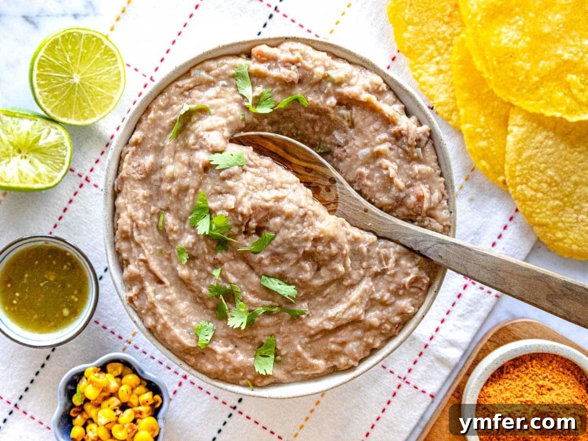 Savory Bean Mash 6 A bowl of creamy refried beans topped with fresh cilantro, ready to be enjoyed