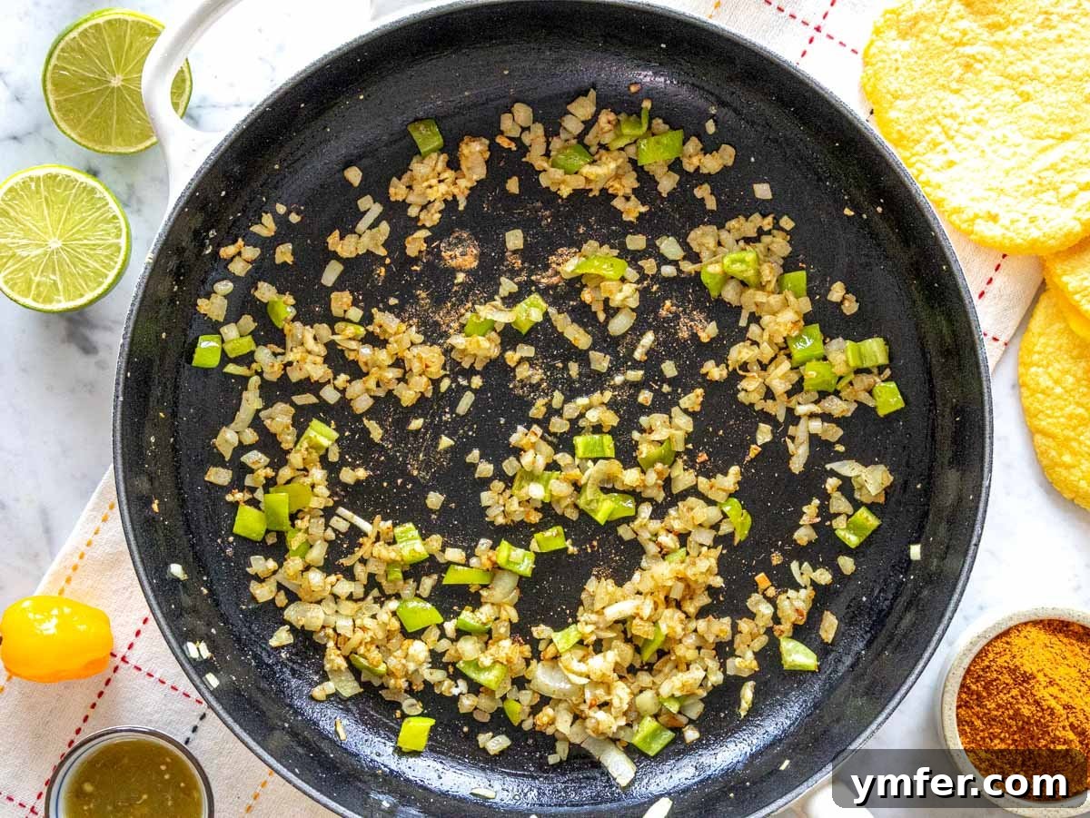 Savory Bean Mash 7 Chopped onion, garlic, and jalapeño sautéing in olive oil in a skillet to form the flavor base for refried beans