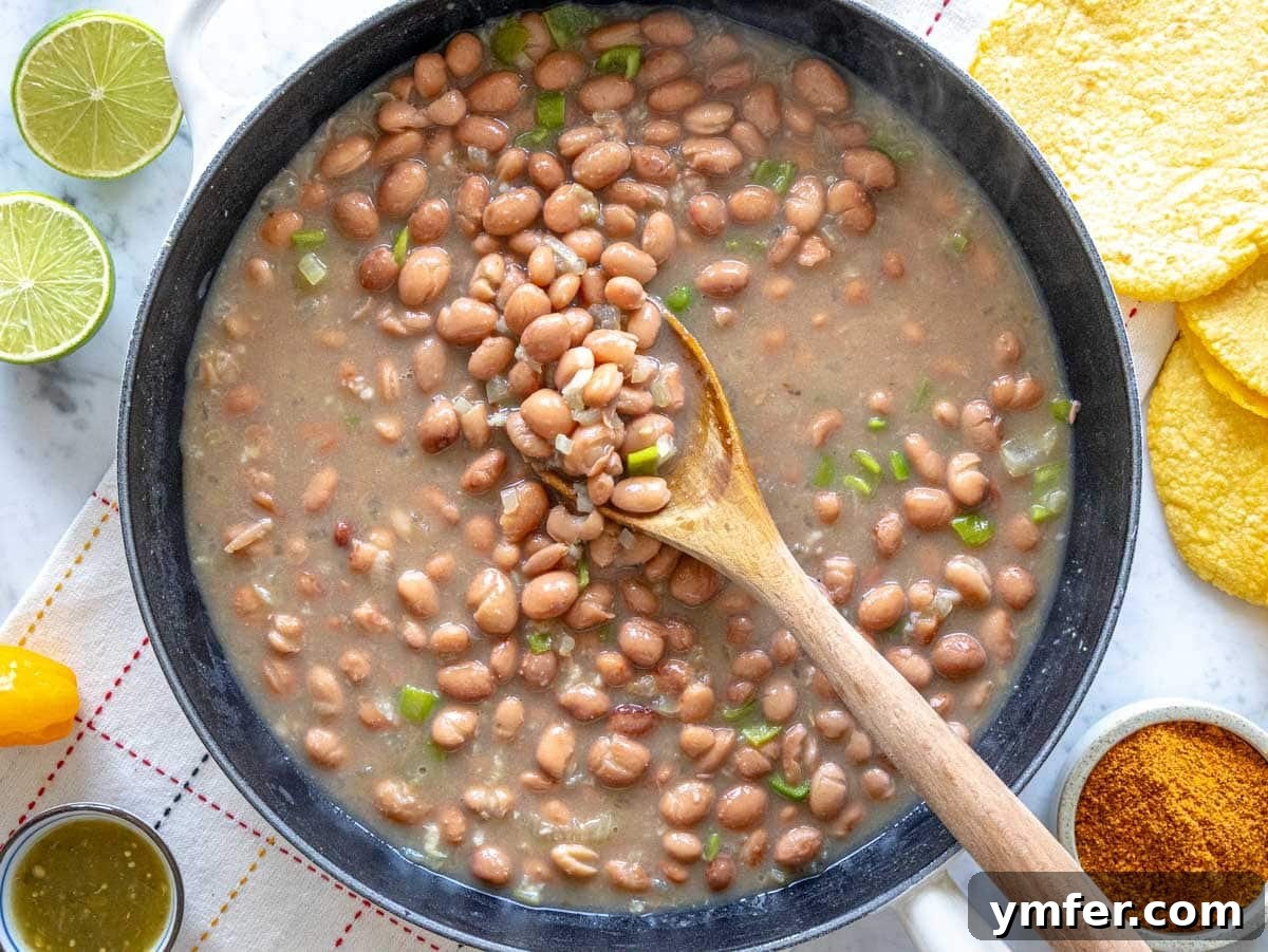 Savory Bean Mash 8 Pinto beans added to the skillet with sautéed aromatics and liquid, ready to simmer