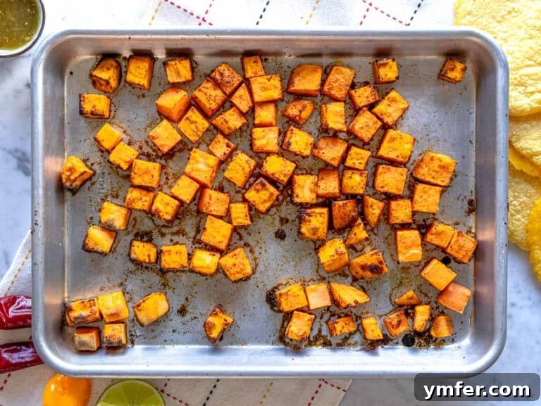 Crispy Topped Tortilla Delights 11 Roasted sweet potatoes with taco seasoning on a baking sheet, ready for tostadas.