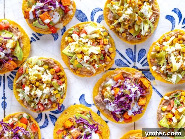 Crispy Topped Tortilla Delights 13 Colorful corn tostadas topped with refried beans, various vegetables, and cheese, ready to be enjoyed.