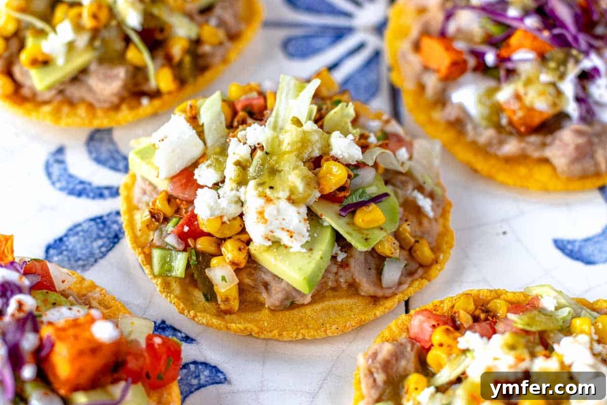 Crispy Topped Tortilla Delights 3 Close-up of a perfectly crafted tostada with layers of fresh ingredients, showcasing its open-faced design and inviting textures.