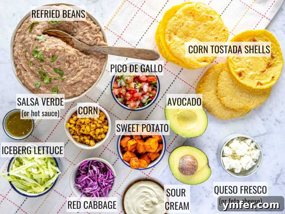 Crispy Topped Tortilla Delights 5 A vibrant array of fresh ingredients for making tostadas, including diced sweet potatoes, corn, refried beans, and various vegetables, ready for preparation.