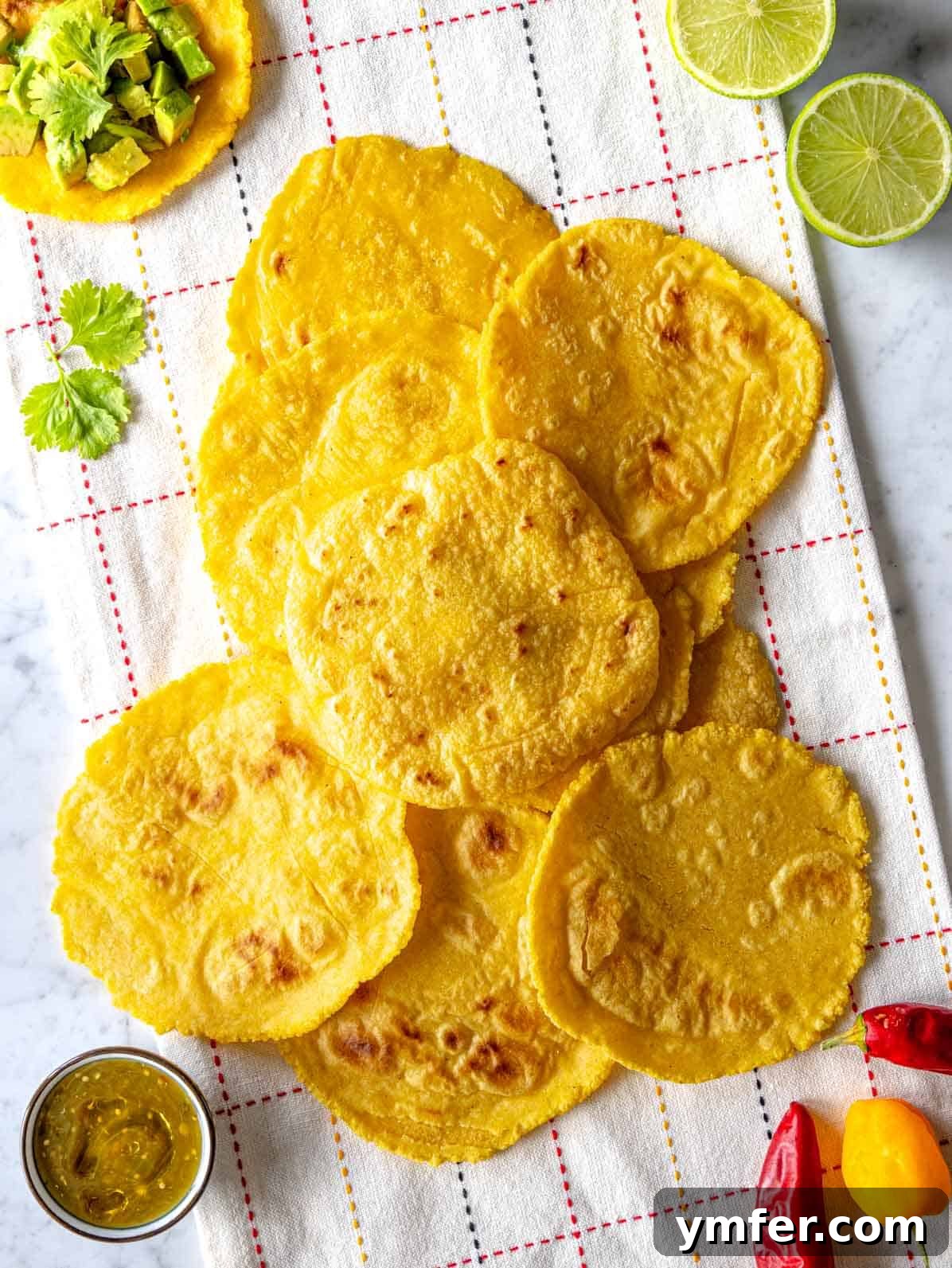 Handcrafted Corn Wraps 2 Freshly made homemade corn tortillas stacked on a kitchen cloth