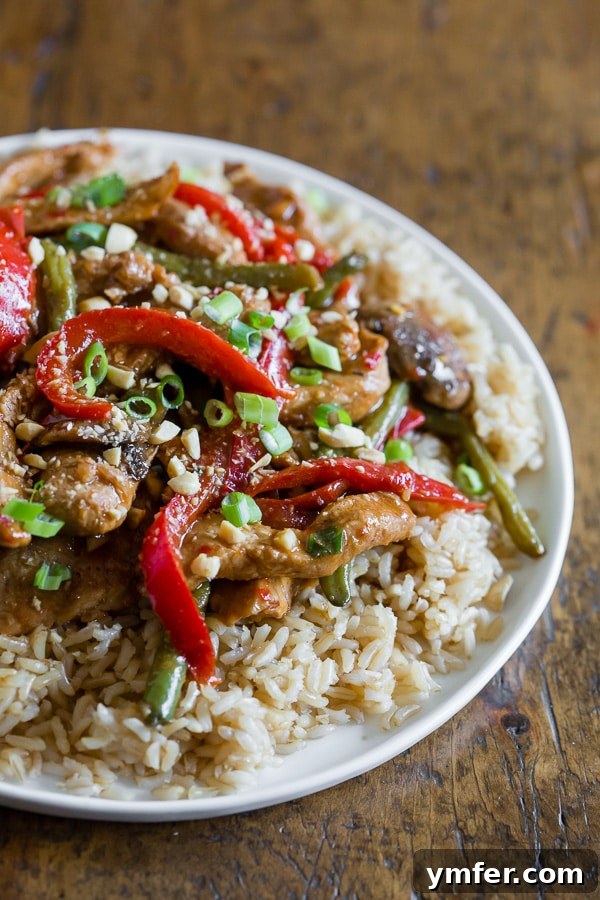 Chili Garlic Pork Wok Toss 3 A portion of Spicy Garlic Pork Stir Fry served alongside fluffy white rice on a plate, highlighting its appetizing presentation.