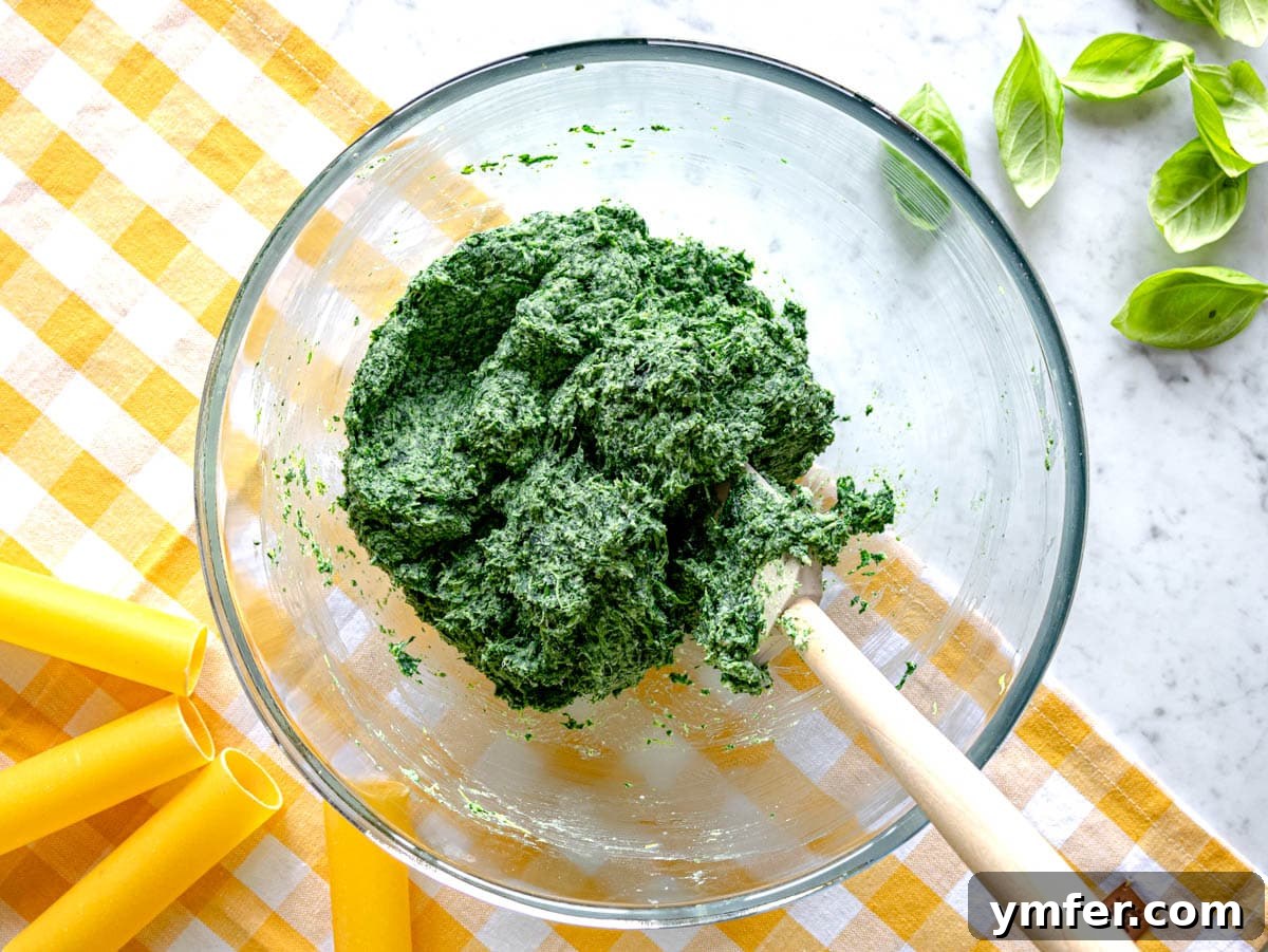 Hearty Stuffed Pasta Bake 7 A bowl of creamy spinach and ricotta filling, perfectly blended, ready for stuffing cannelloni.
