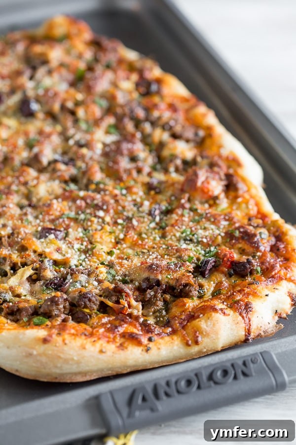Robust Puttanesca Beef Pizza 3 Beef Puttanesca Pizza on a sheet pan.