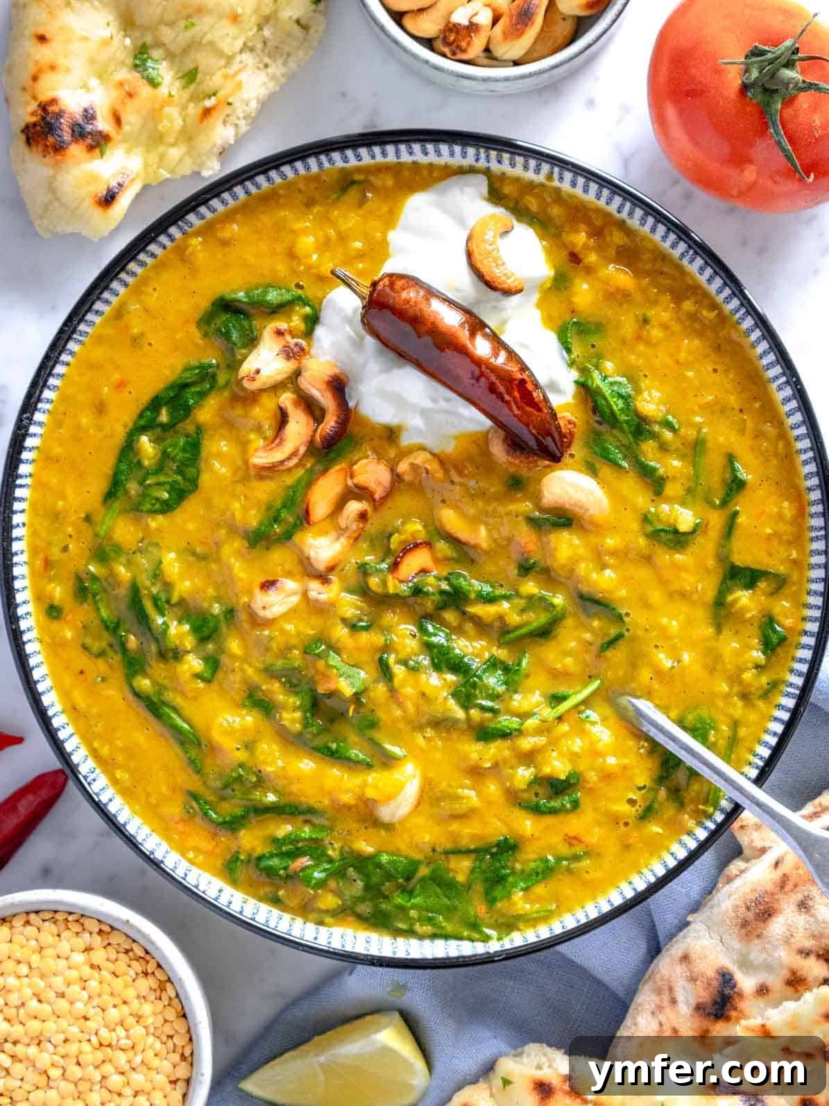 Creamy Dal with yogurt and cashew nuts in a bowl, garnished with fresh herbs, ready to be served.