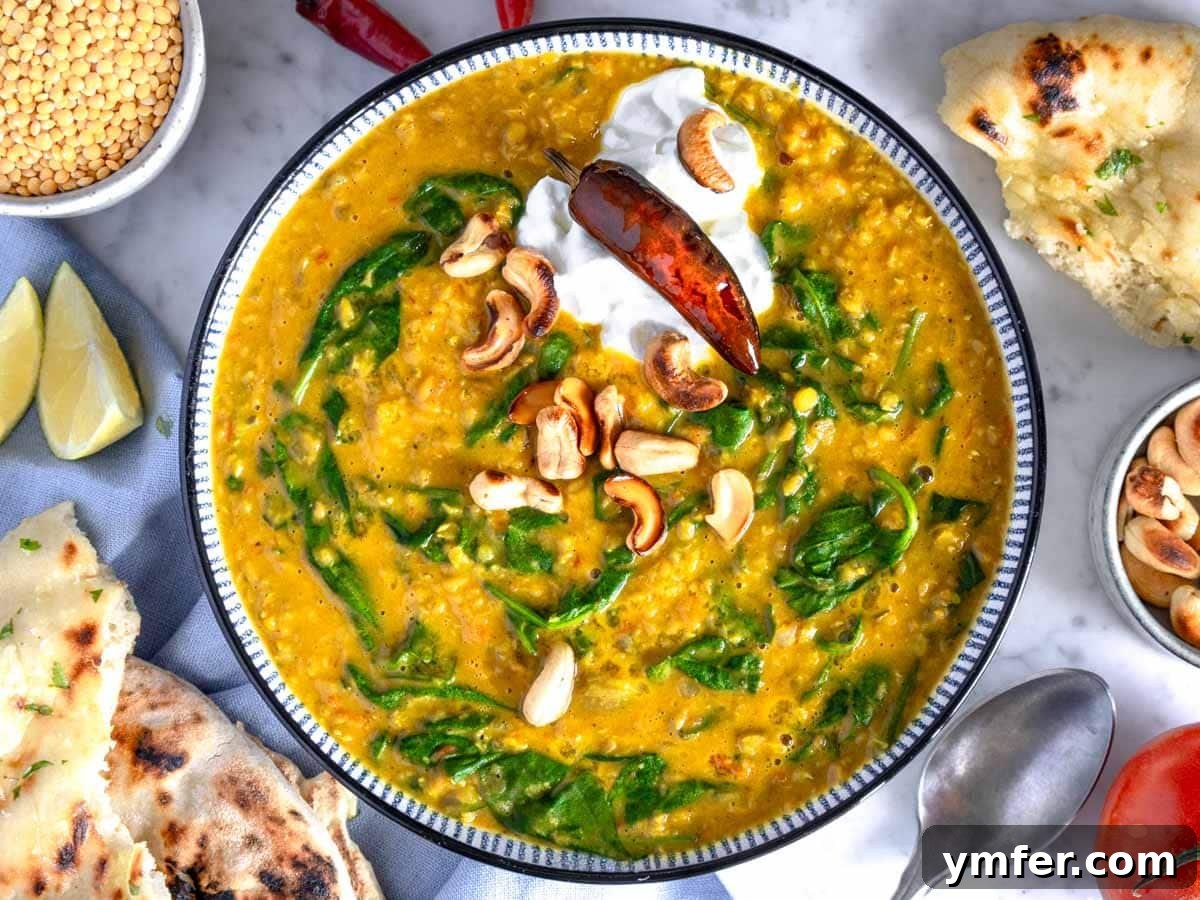 A beautifully presented bowl of creamy dal, topped with fresh herbs, ready to be served, highlighting its rich texture and inviting aroma.