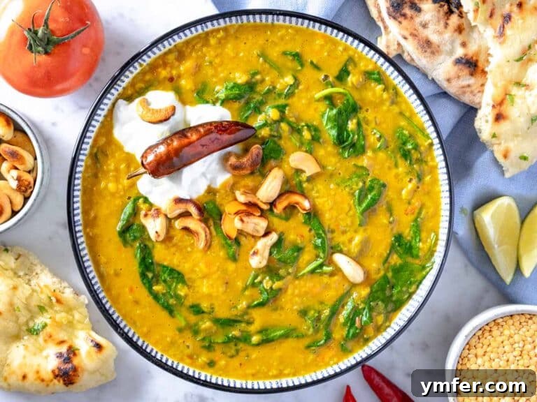 Creamy dal served with yogurt, cashews, and a slice of lemon for garnish.