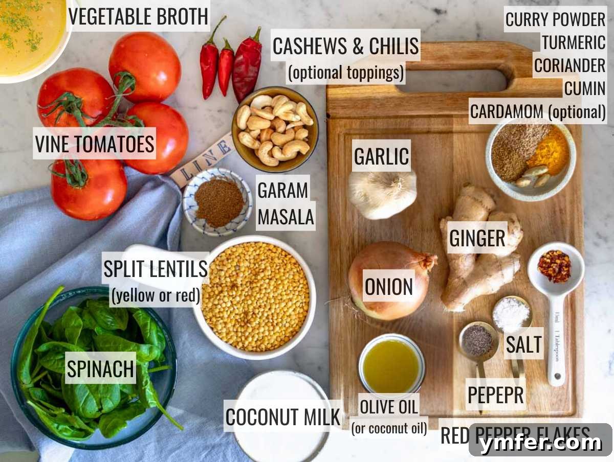 A curated display of fresh ingredients for dal, including yellow split lentils, tomatoes, spinach, ginger, garlic, onion, olive oil, and various spices.