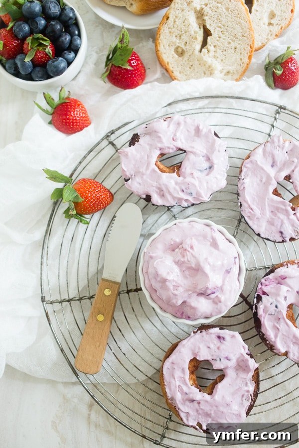 Creamy Berry Indulgence 3 A small white bowl filled with creamy, purple-hued roasted berry cream cheese, ready to be served.