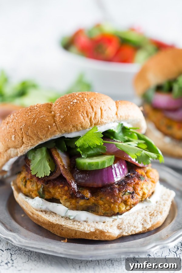 The Tandoori Flame Burger 2 This chicken tandoori burger is packed full of spices and fresh chopped herbs. Piled high with fresh cilantro, cucumber, grilled onions and Greek yogurt sauce. This burger is perfect for all your summer BBQ parties!