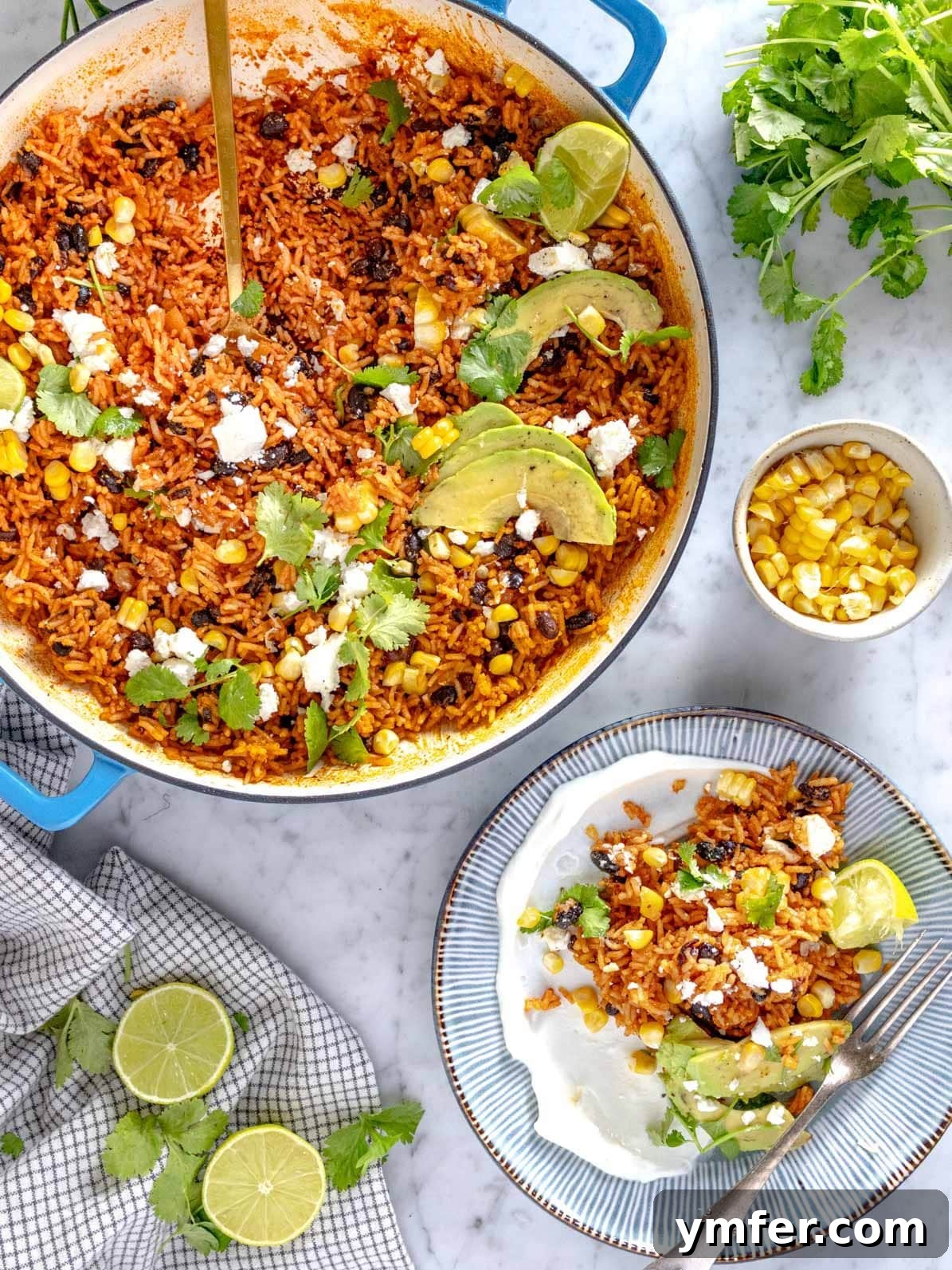 Zesty Fiesta Rice 2 Mexican rice served with lime and corn on the cob, showcasing a vibrant and appealing one-pot meal