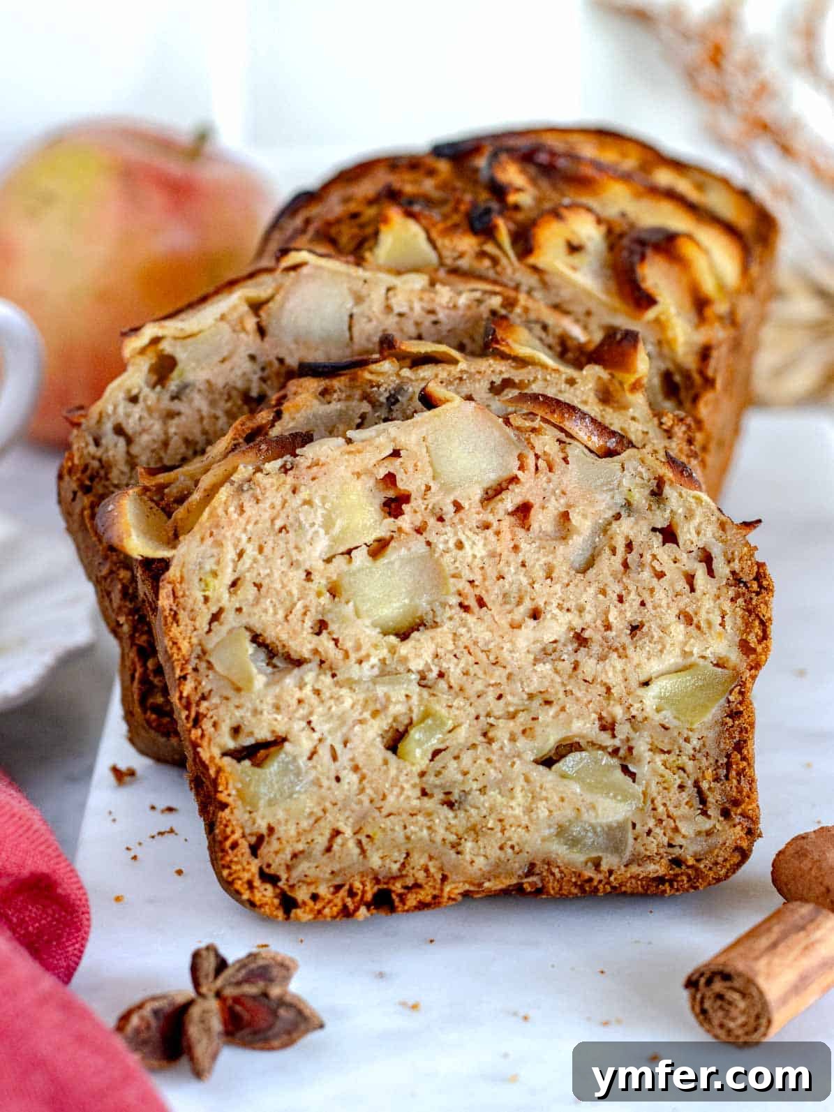 Multiple slices of healthy apple bread, showing the baked apple pieces and soft texture.