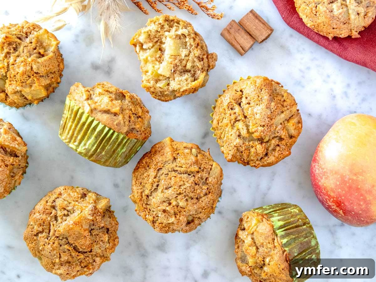Orchard Spice Muffins 6 Apple muffins cooling down on a marble table