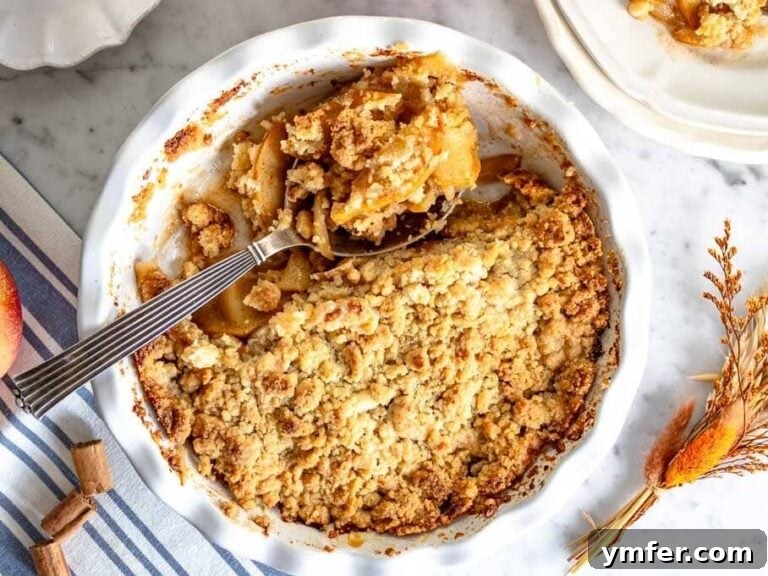 Apple crumble in pie dish and a cup of coffee