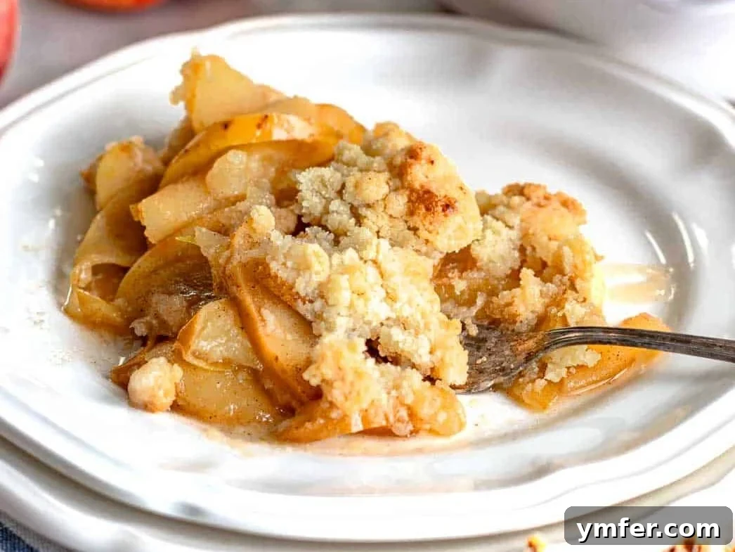 Golden Apple Crumble Perfection 4 A scooped put portion of apple crumble on a white plate