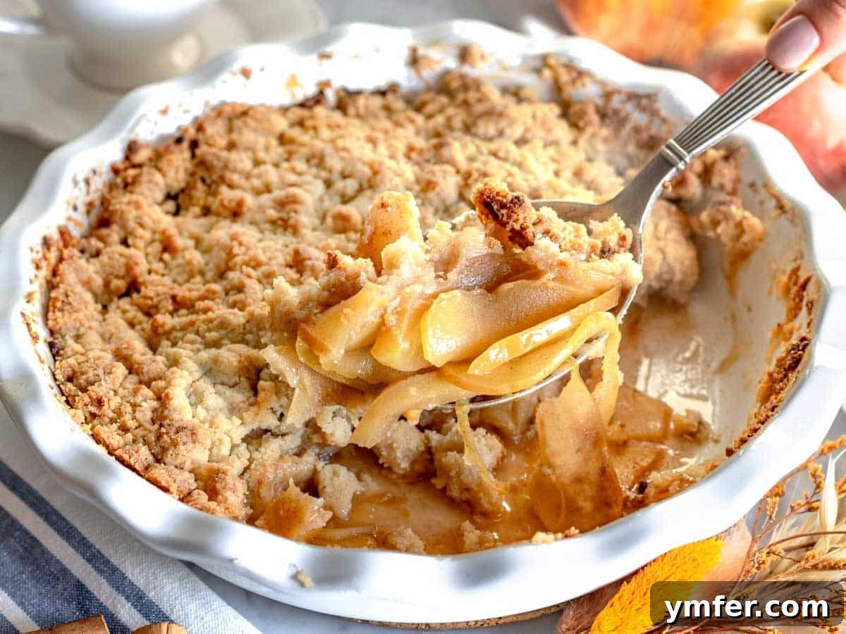 Golden Apple Crumble Perfection 10 Apple crumble with a silver spoon
