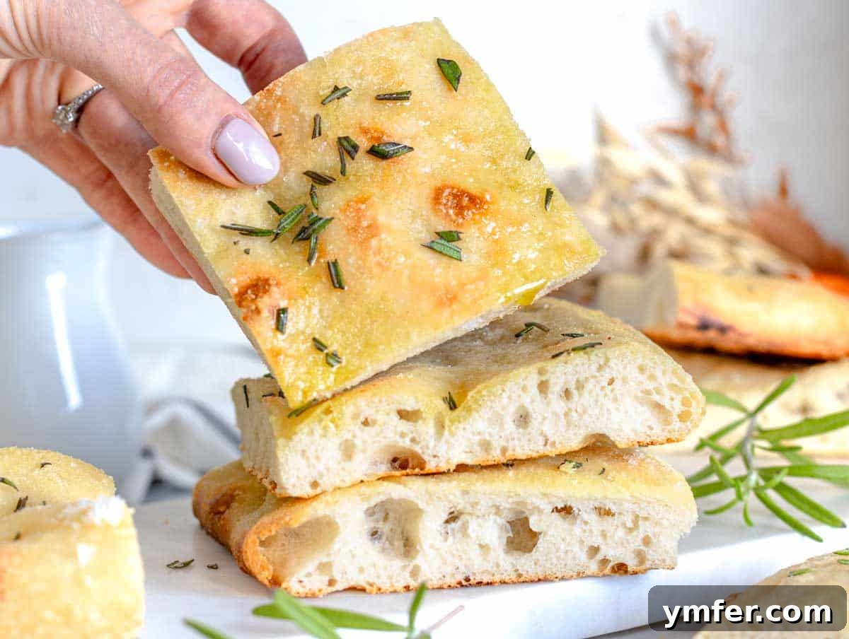 Golden Olive Oil Flatbread 15 Louise holds a piece of schiacciata