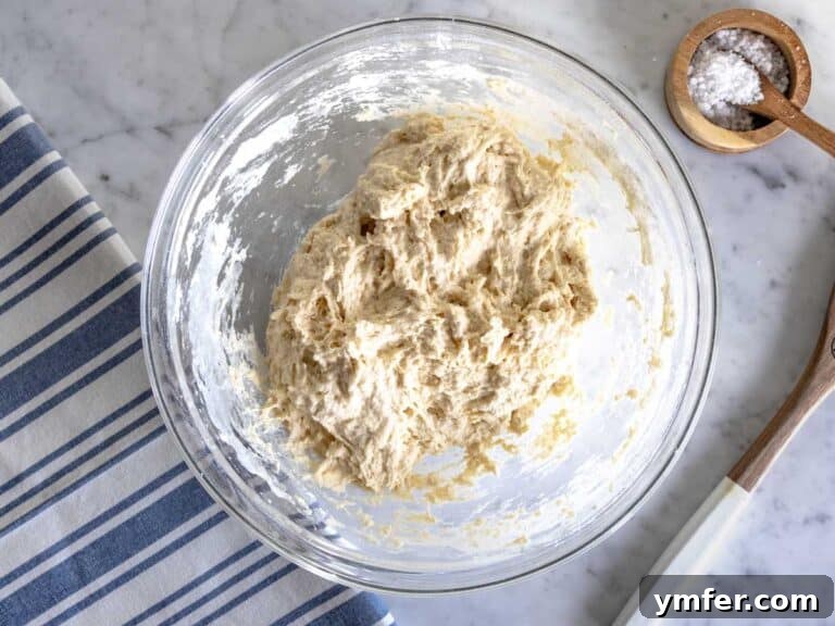 Golden Olive Oil Flatbread 18 Mixing flour and salt with the water-yeast mixture.