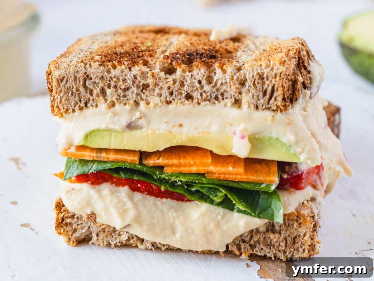 Fuel Your Morning: 30 Plant-Powered Breakfast Creations 14 Hummus sandwich up close on a white cutting board