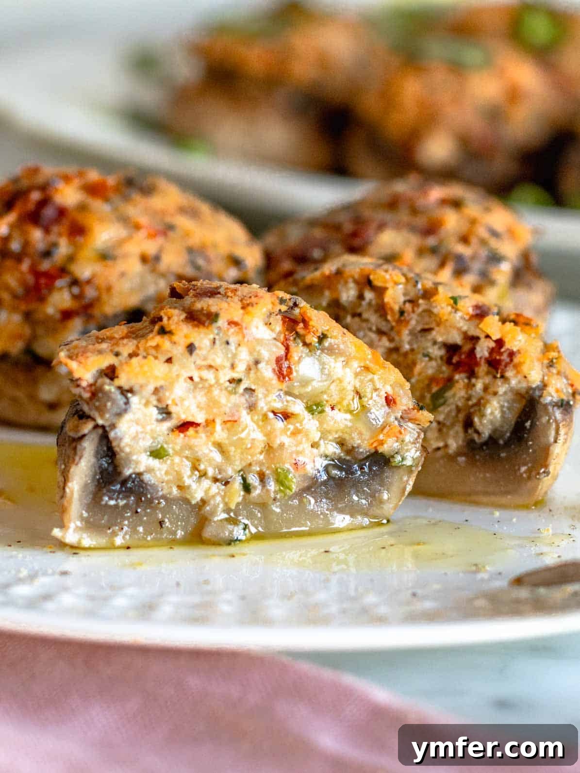 Savory Stuffed Delights 2 stuffed mushrooms with ricotta cut into half on a plate, showcasing the creamy filling