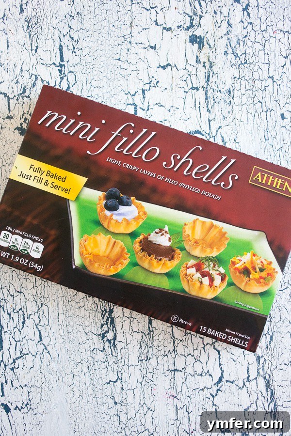 Crispy Tequila Lime Shrimp Phyllo Cups 4 A vibrant red box of Athens mini phyllo shells sits on a rustic wooden table, emphasizing the convenience and quality of the product.