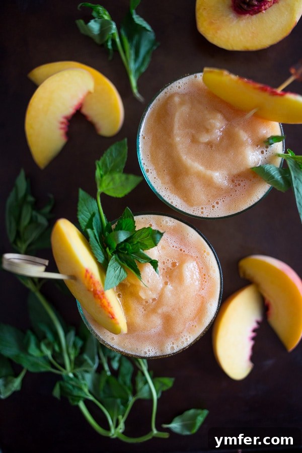 Sweet Peach Tea Bourbon Freeze 2 Refreshing Peach Tea Bourbon Slushie garnished with fresh peaches and mint